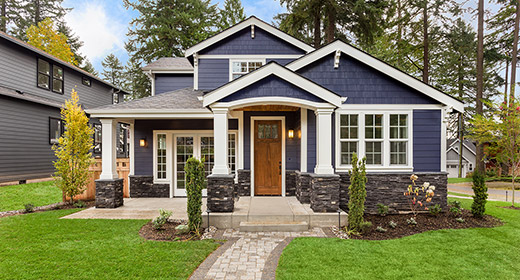 View from the front walkway of a two story home with blue siding and a red front door