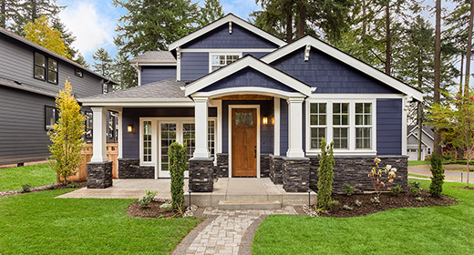 Exterior view of a new construction home with blue siding and a brown front door (1)