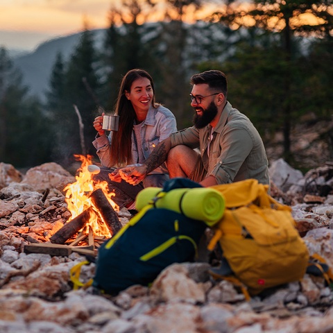 man and woman by a campfire_480x480