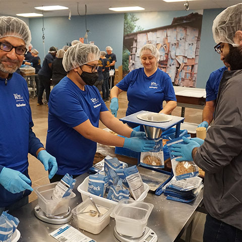 wings volunteers packing food donations_2